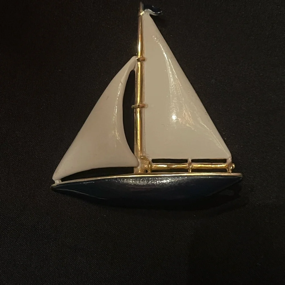 Gold tone sailboat brooch with white and blue enamel